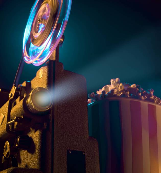 Vintage old fashioned projector in a dark room projecting a film, cinematography concept